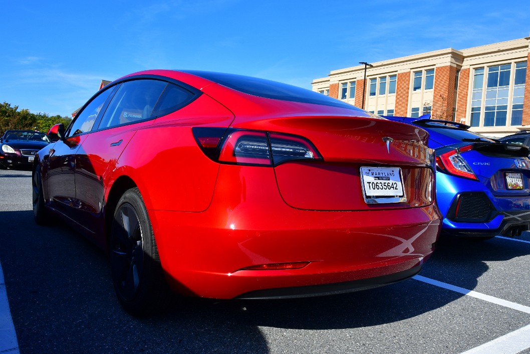 Rear Side View of a Red Tesla Model 3