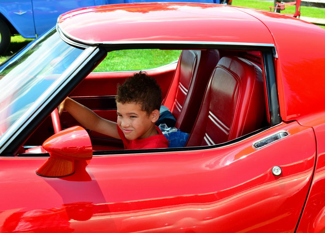 Malachi Behind the Wheel of a Red Corvette Malachi Behind the Wheel of a Red Corvette